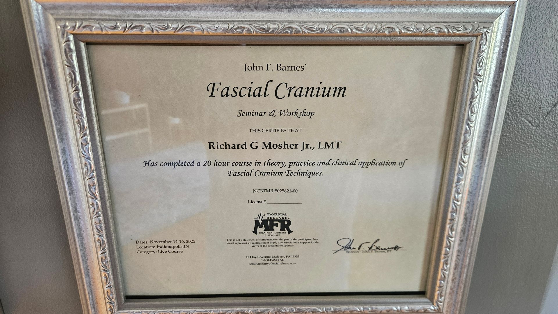 Framed medical diploma on a wall, titled 