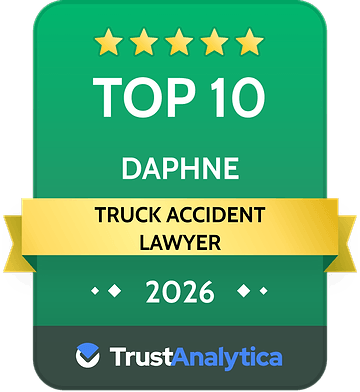 Green TrustAnalytica badge reading “Top 10 Daphne Truck Accident Lawyer 2026” with gold stars and ribbon
