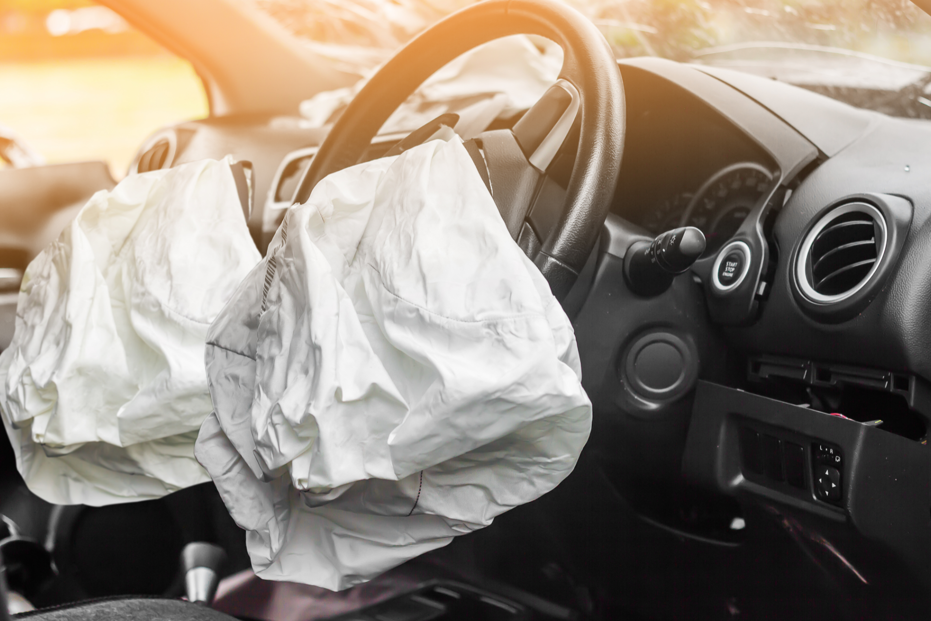 Deployed driver and passenger airbags inside a car after a crash