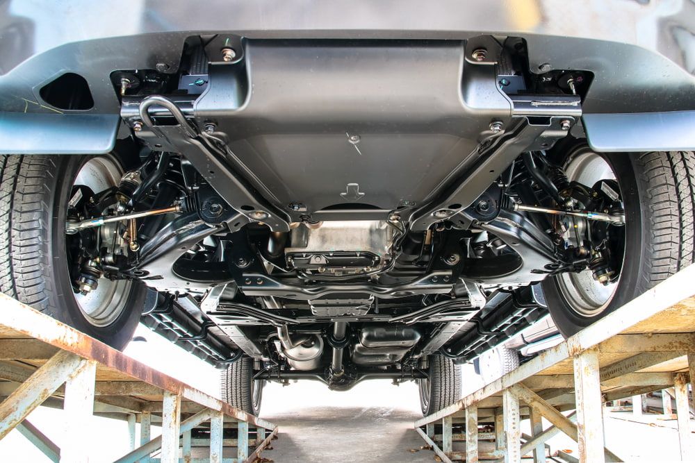 The Underside of a Car is Shown on a Lift — Protec Mechanical Repairs In Taree, NSW