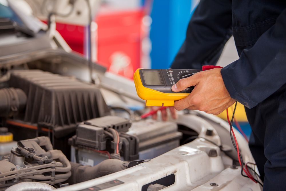 A Mechanic is Using a Multimeter to Check the Voltage — Protec Mechanical Repairs In Taree, NSW
