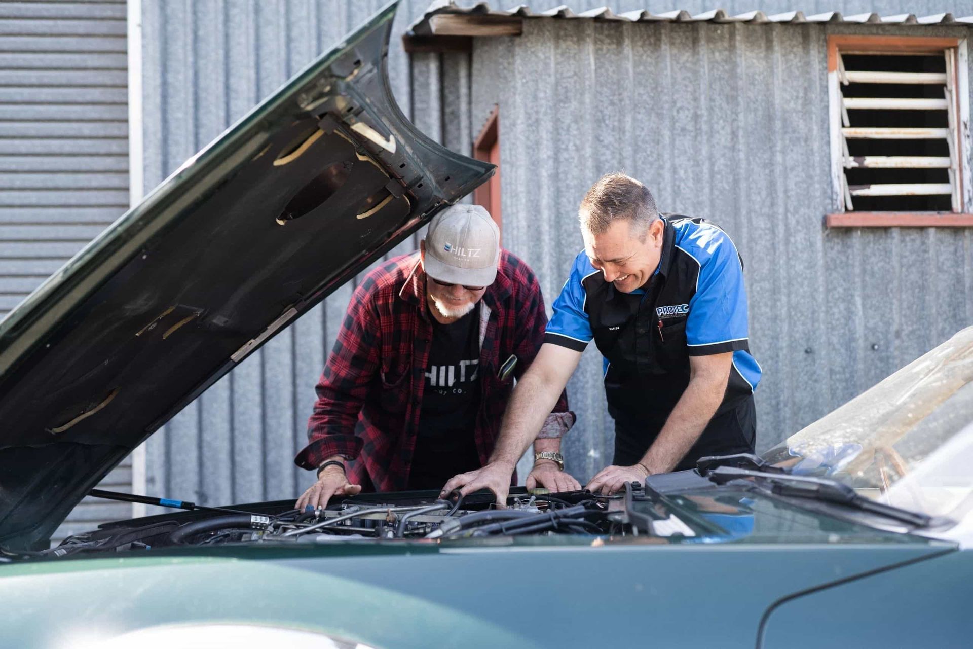 Two Men Are Working on a Car With the Hood Open — Protec Mechanical Repairs In Taree, NSW