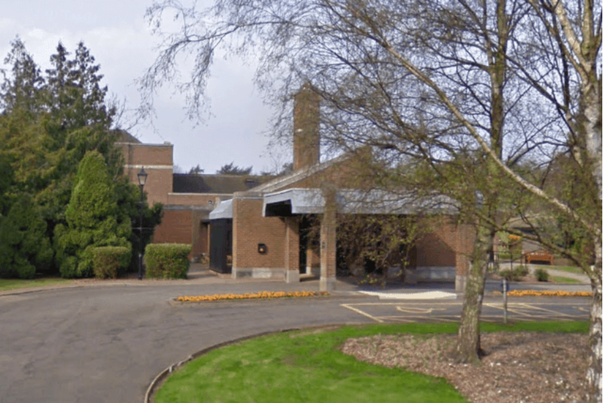 A large brick building with trees in front of it