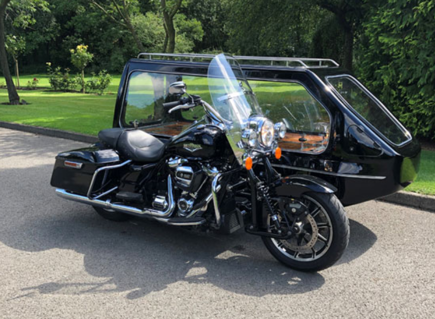 A black harley davidson motorcycle with a sidecar attached to it