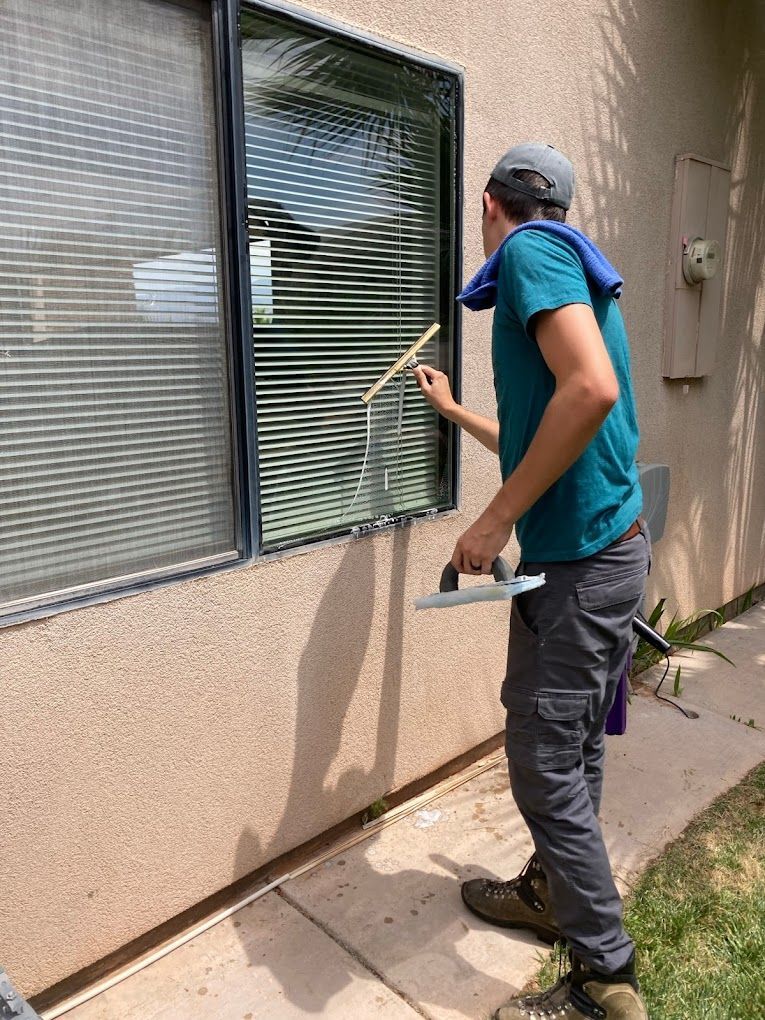 Closing Cleaners professionally cleaning windows with a mop and squeegee utilizing the s technique for streak free shine