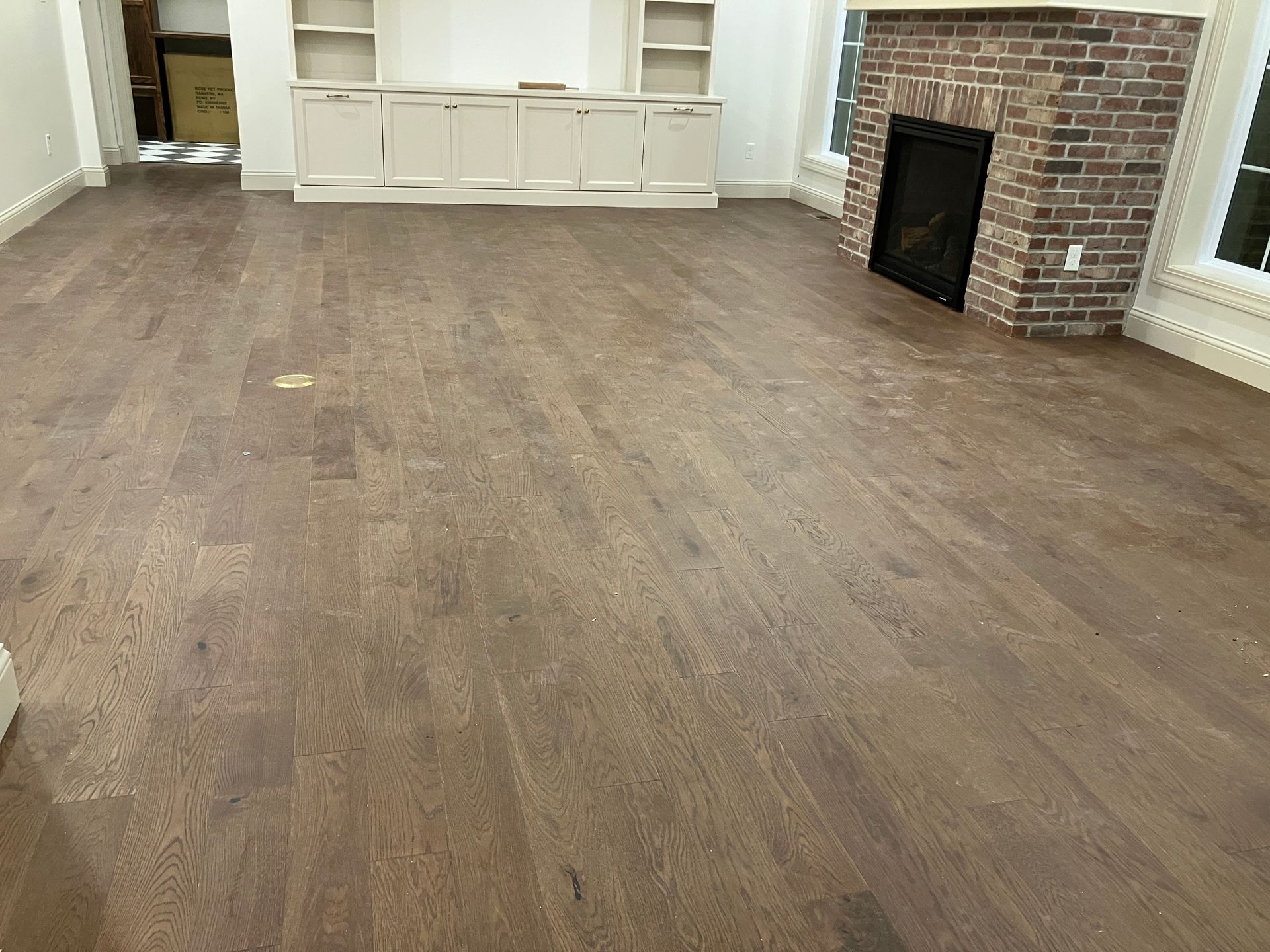 Post-Construction site with a fine layer of dust covering the floor prior to cleaning.