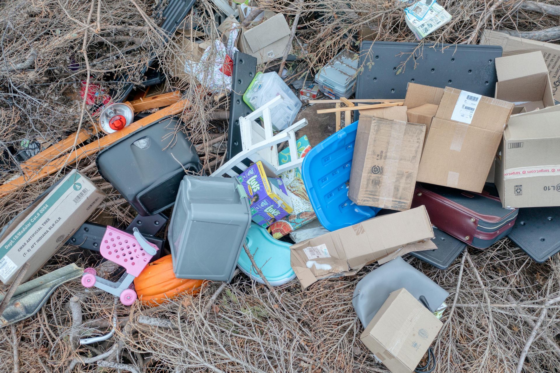 Garbage, junk, and other items piled up outside on a trash pile ready for clean up services.