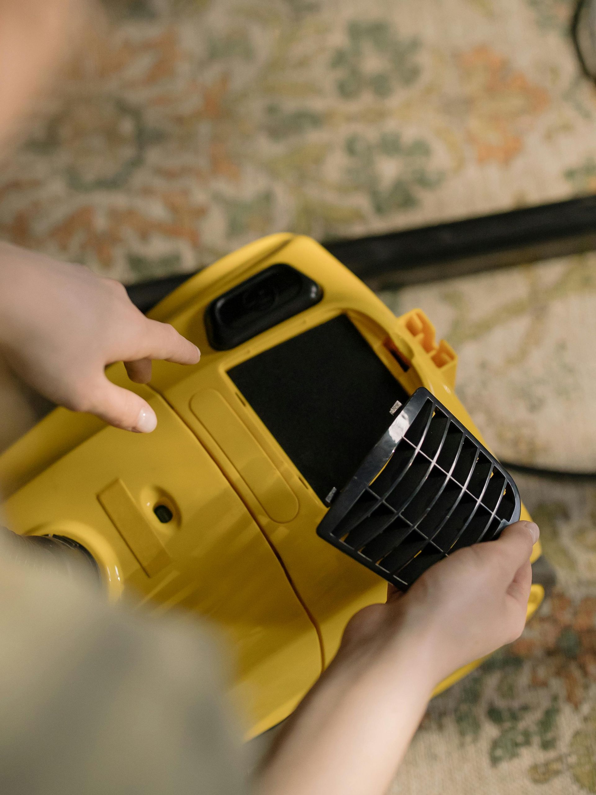 Closing Cleaners vacuum filter being replaced in a yellow industrial vacuum.