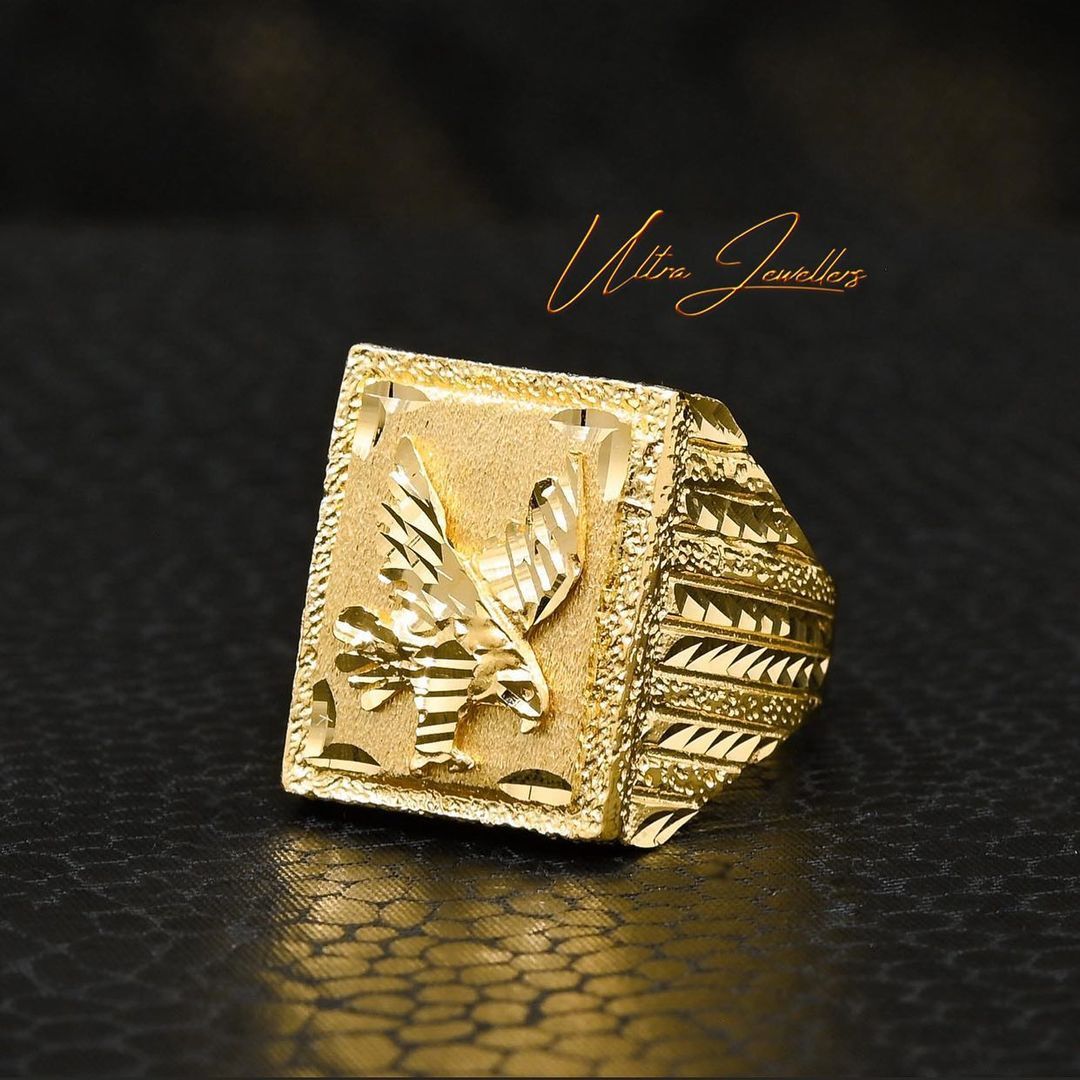 A gold ring with an eagle on it