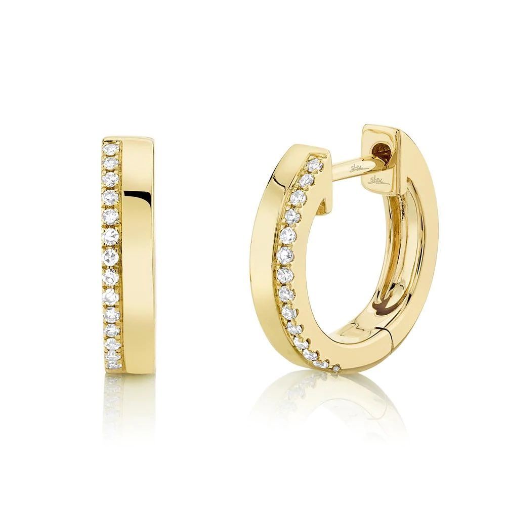 A pair of yellow gold hoop earrings with diamonds