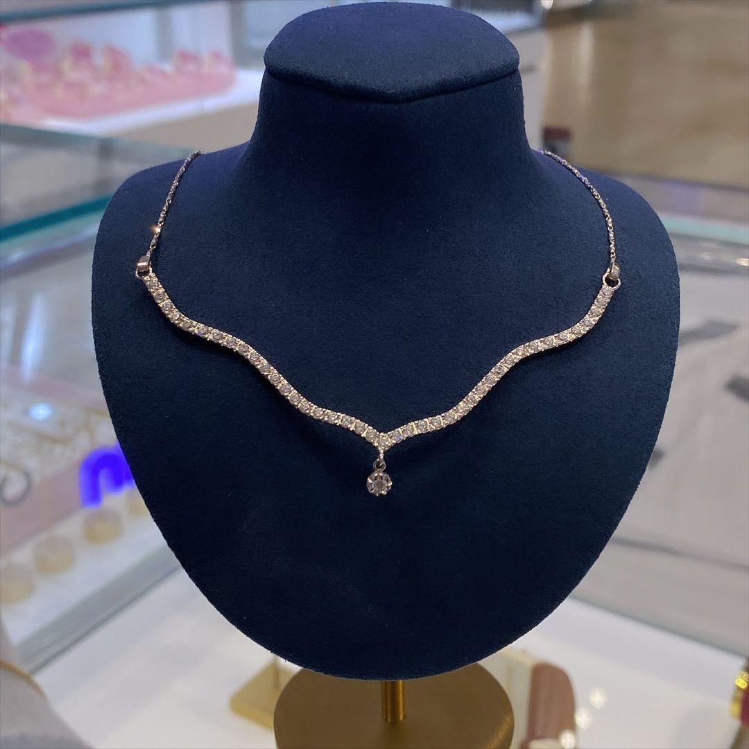 A black mannequin with a necklace on it