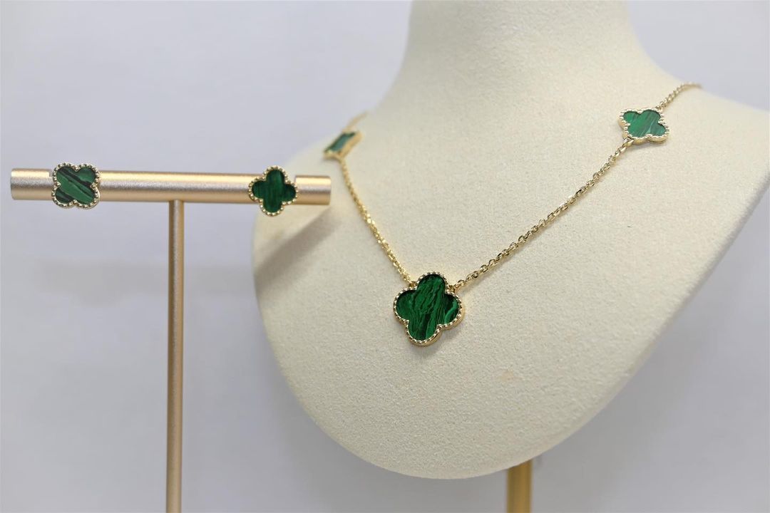 A necklace and earring set on a mannequin.