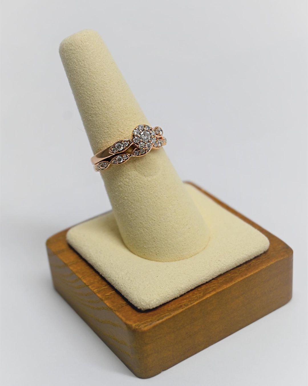 A ring is sitting on a wooden display stand