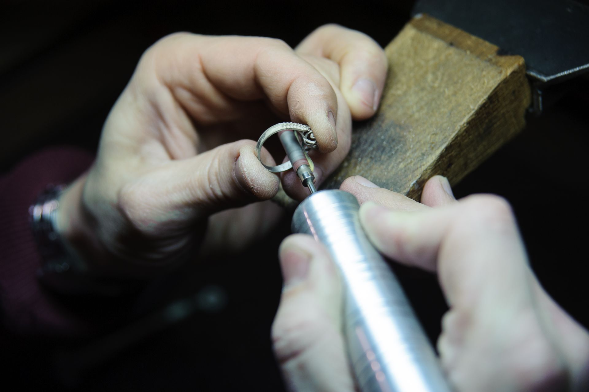 A person is working on a ring with a machine.