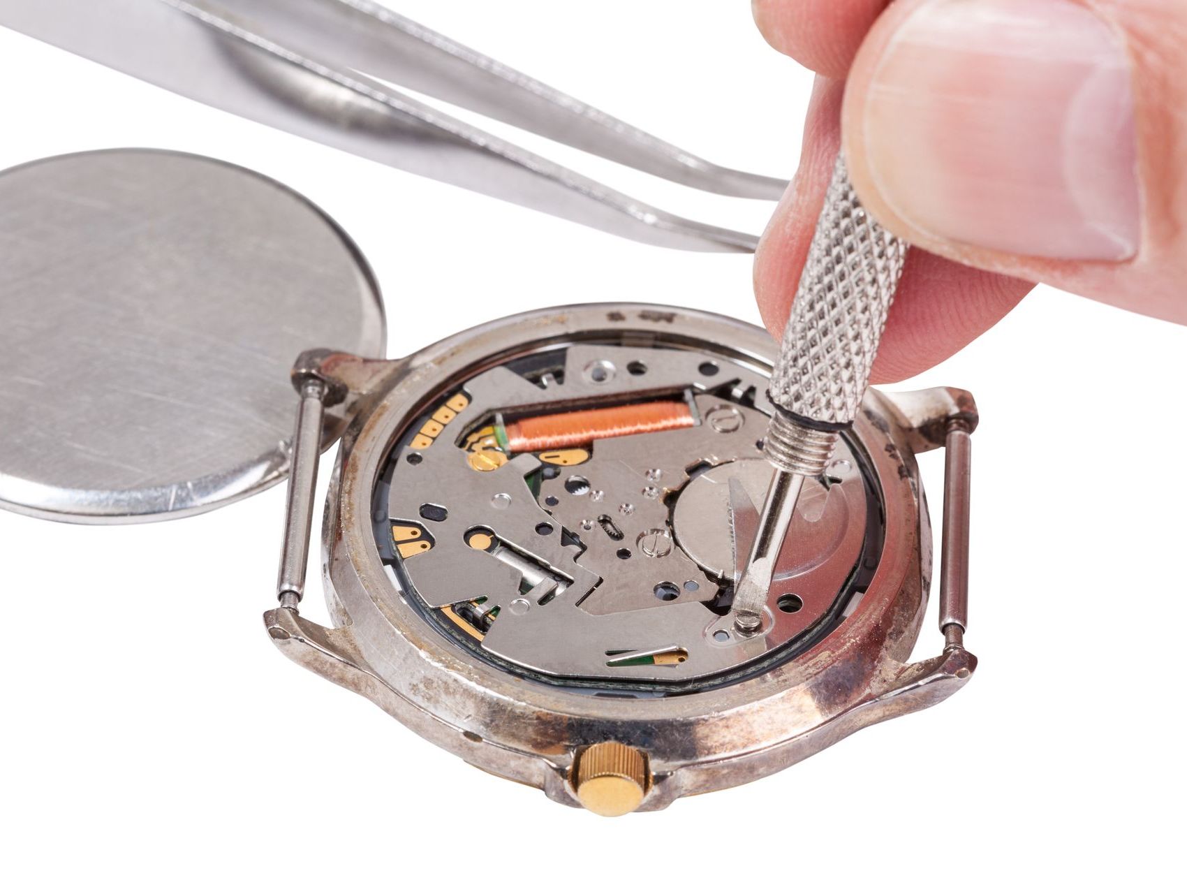 A person is working on a watch with tweezers