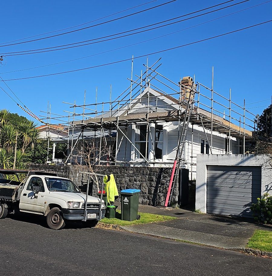 House under construction with roof framing and scaffolding