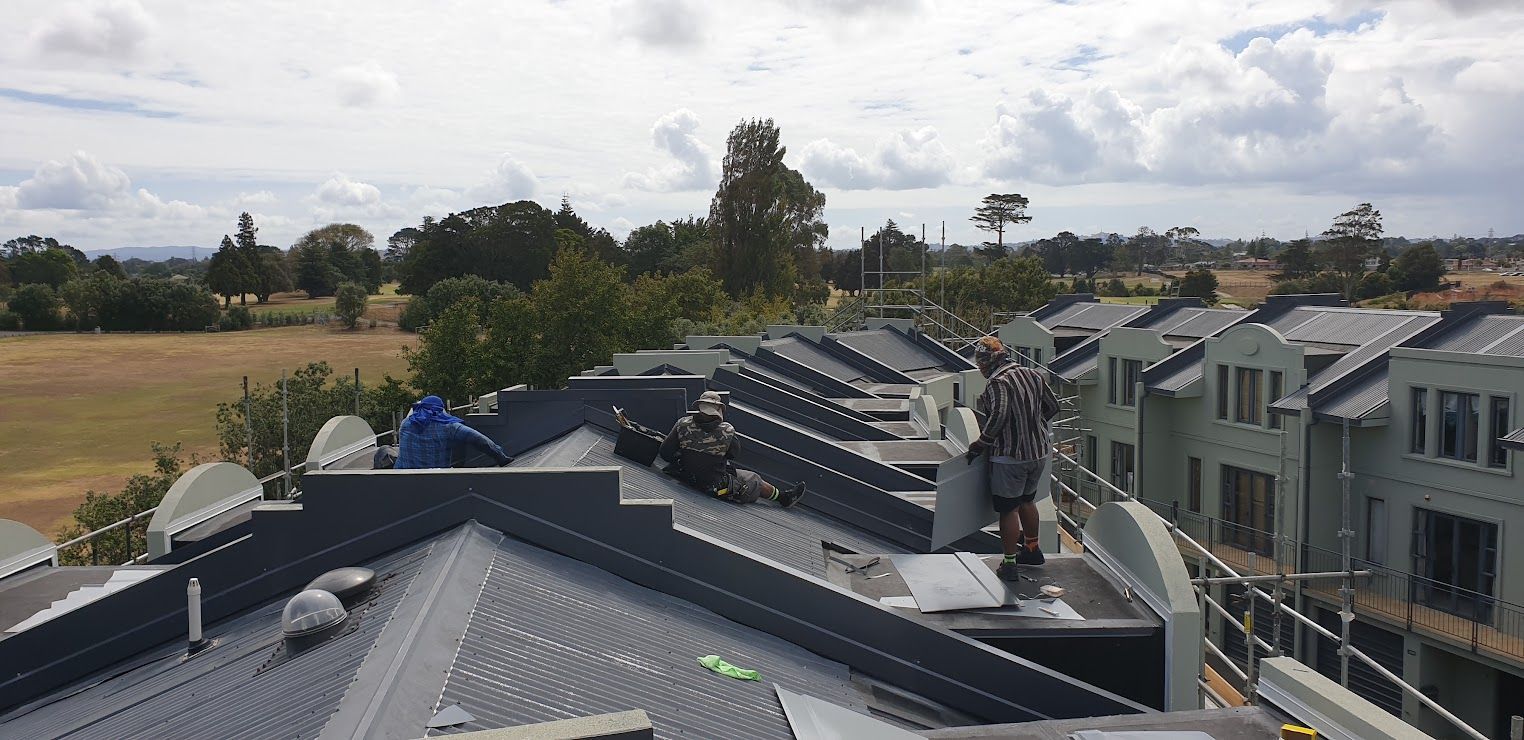 Aerial view of rooftops with solar panels and countryside beyond
