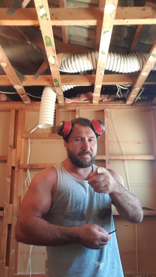 Close-up of wood roof framing with insulation duct