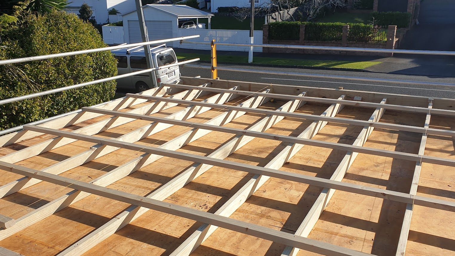 Roof deck framing with plywood panels and safety railing