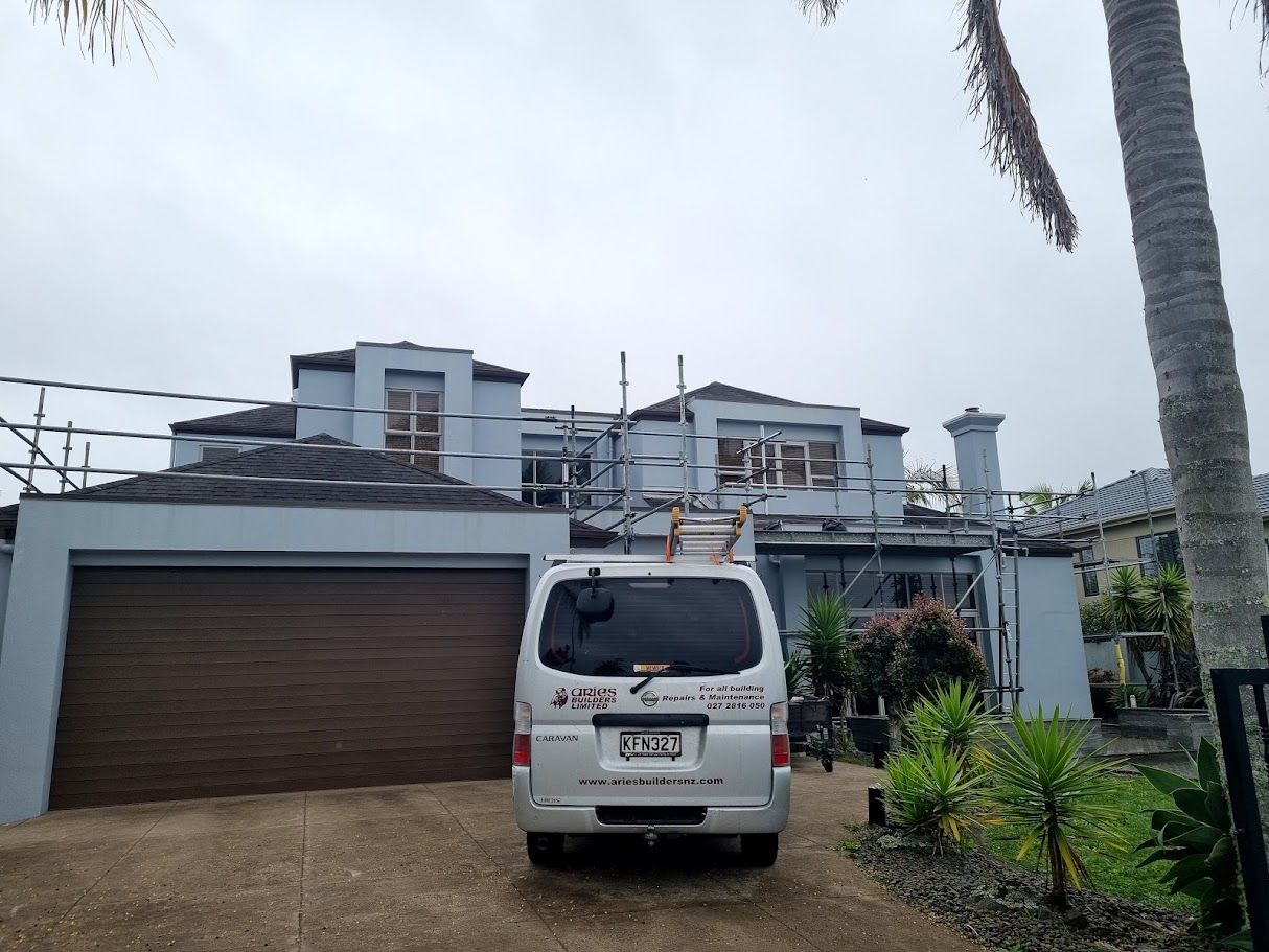 Apartment buildings with scaffolding under a cloudy sky