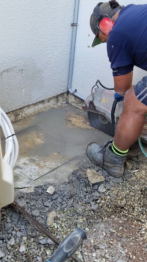 Man wearing ear protection working on an exterior wall