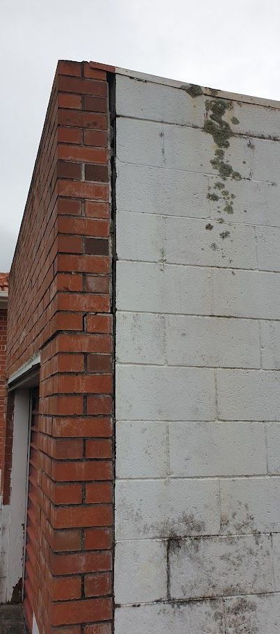 bricks moving away from block wall
