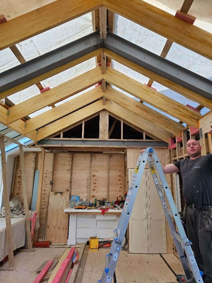 Close-up of a timber roof ridge with a steel support beam