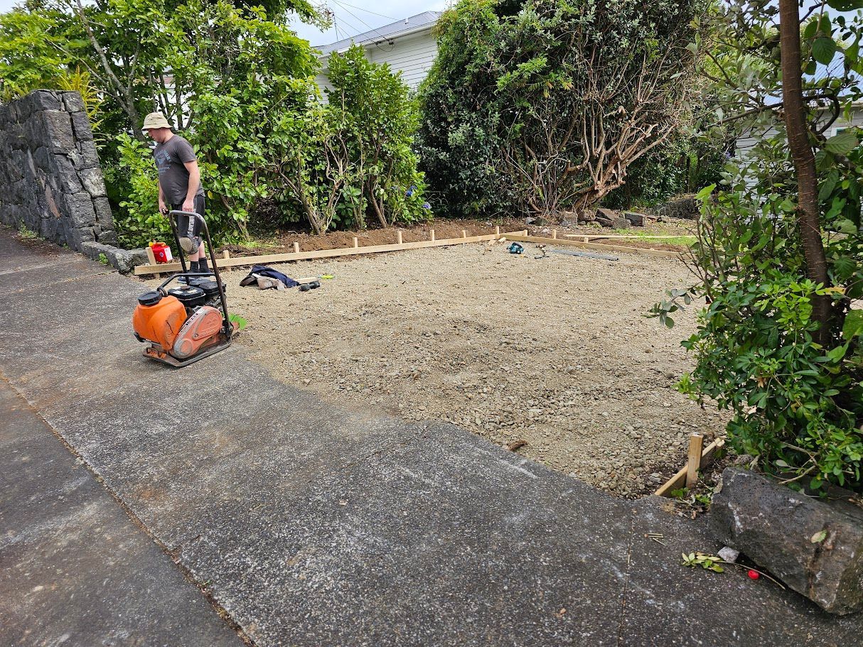 Person clearing an overgrown garden with tools