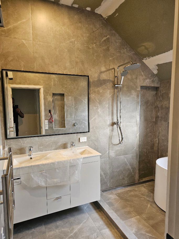 Curved gold-toned textured feature wall in a bathroom