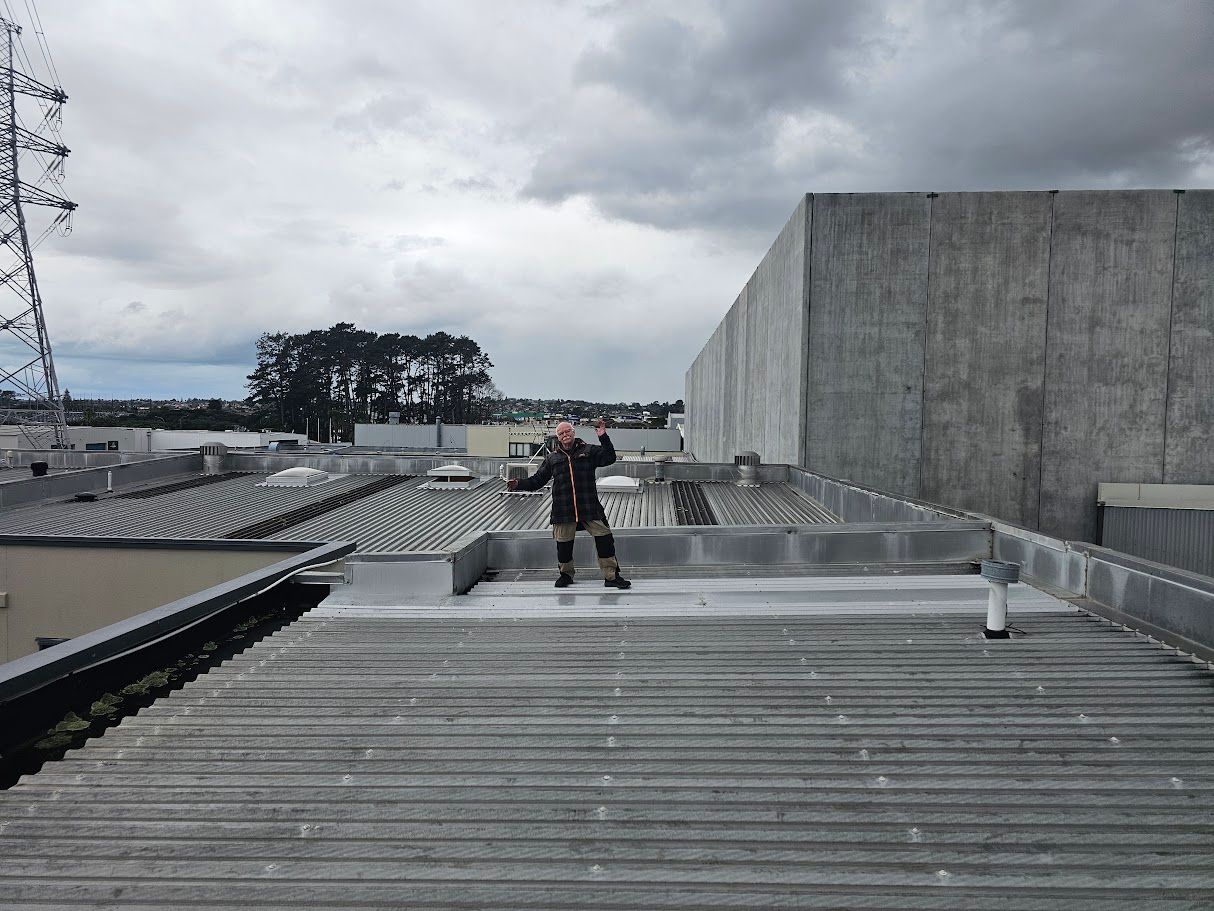 Large concrete tilt-panel wall under an overcast sky