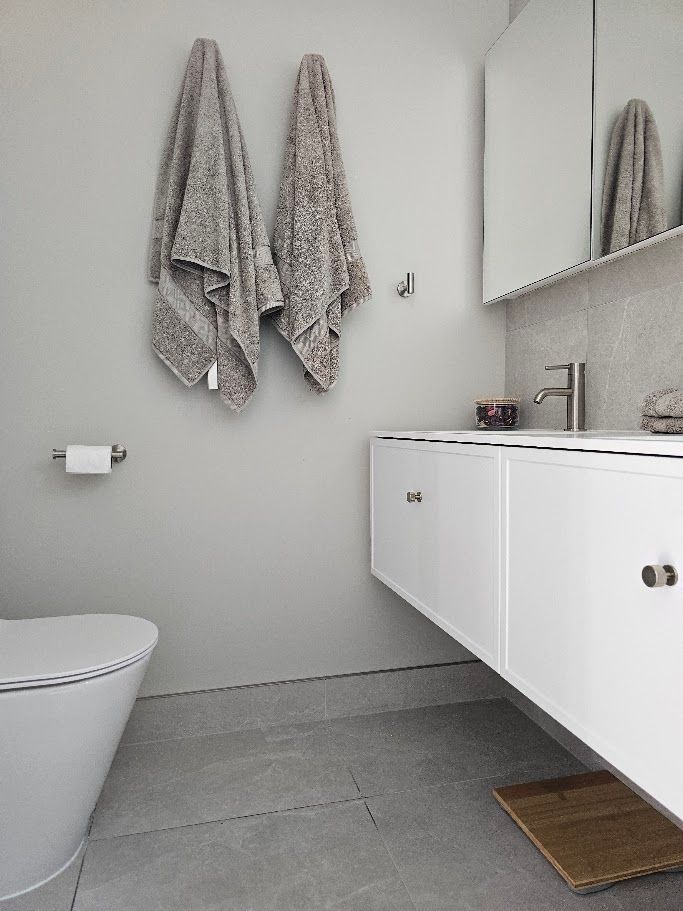Towels hanging on hooks in a bathroom