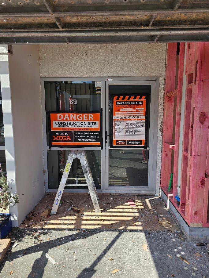 Construction site entrance with a danger warning sign