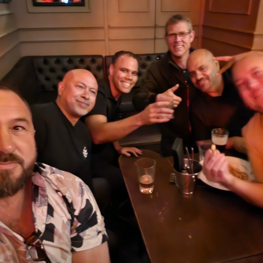 Group of men posing together indoors