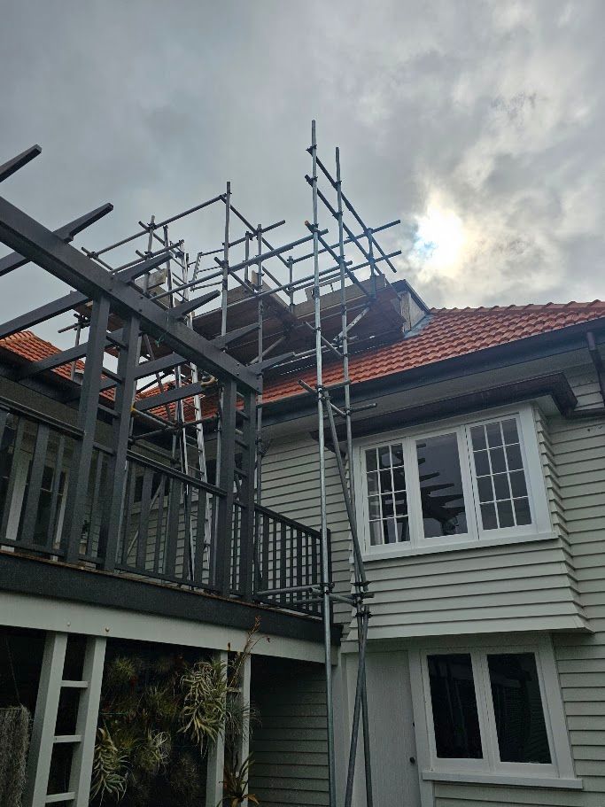 Roof frame scaffolding silhouetted against a cloudy sky