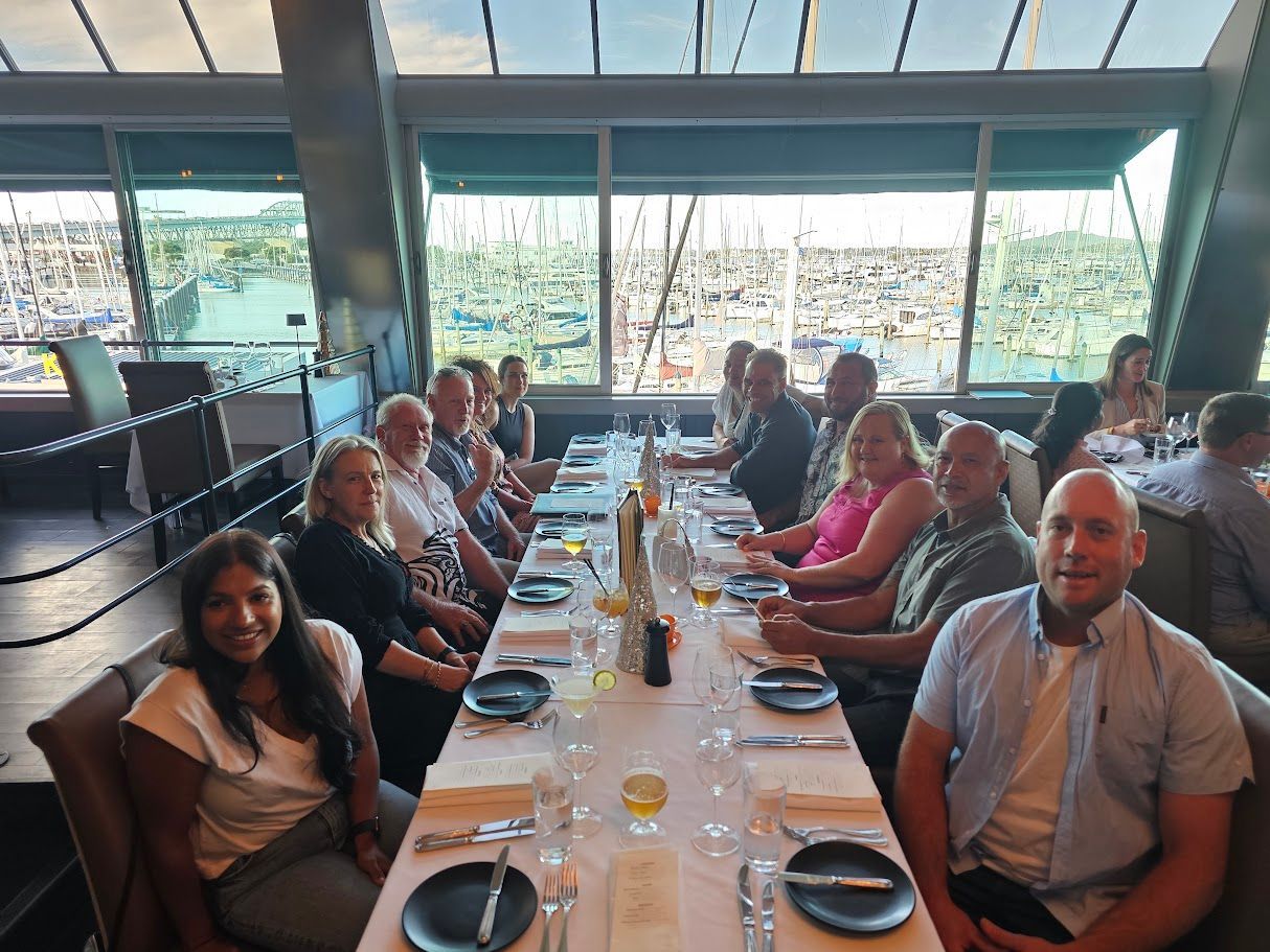 People dining at a restaurant overlooking a marina