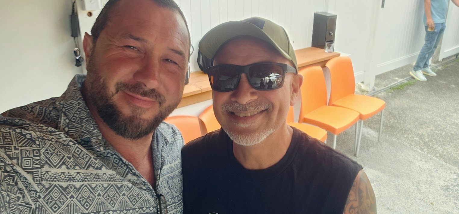 Two men taking a selfie outdoors