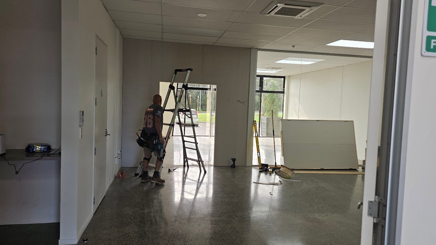 Interior hallway under renovation with a ladder