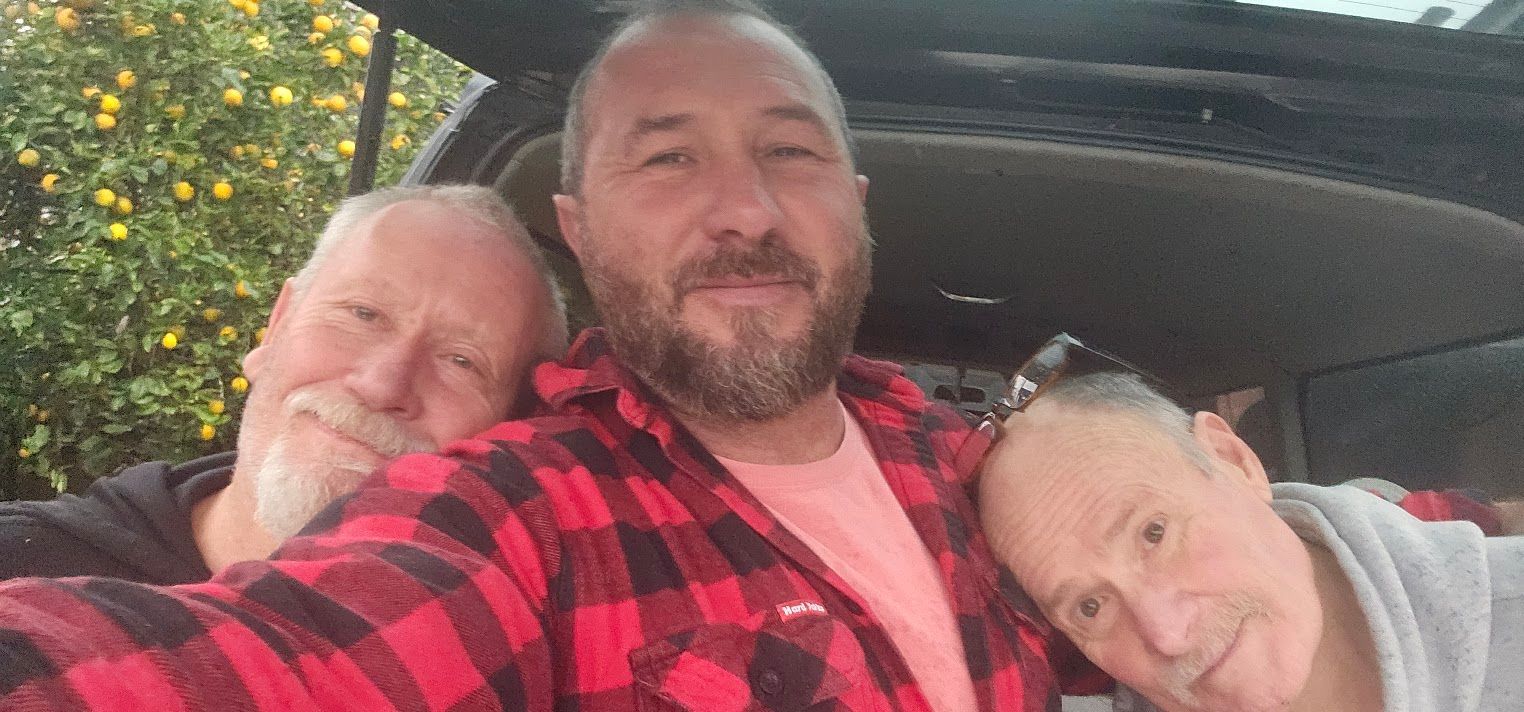 Two men taking a selfie in a car