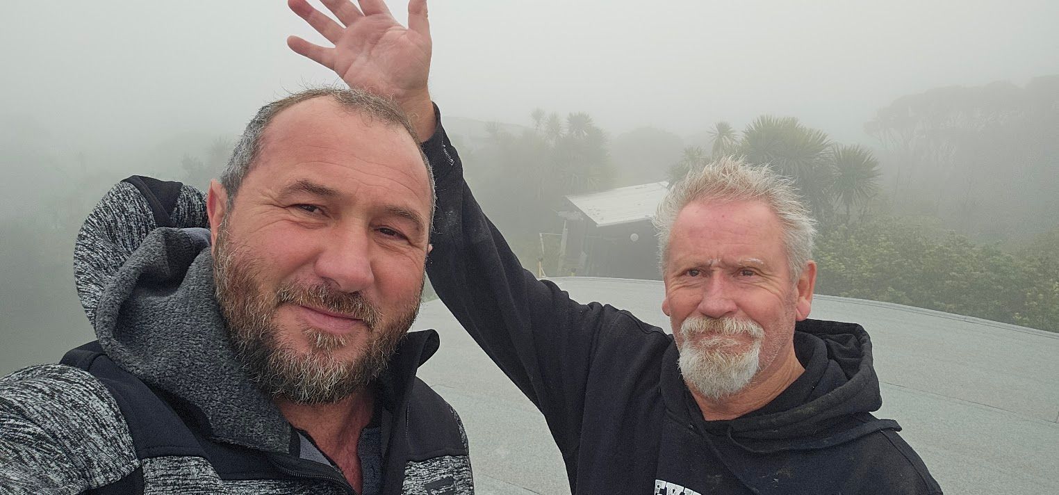 Two men taking a selfie in foggy outdoor weather