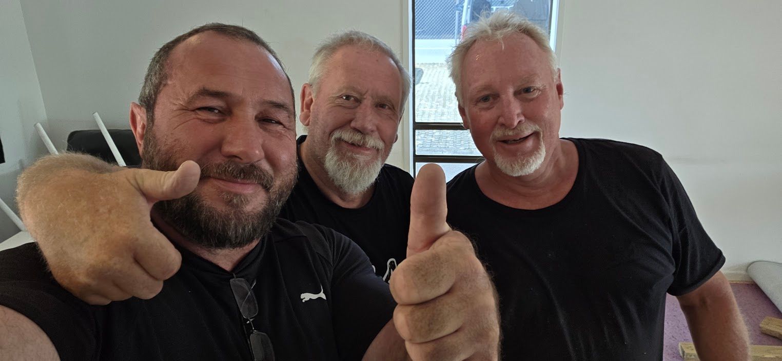 Three men taking a selfie indoors