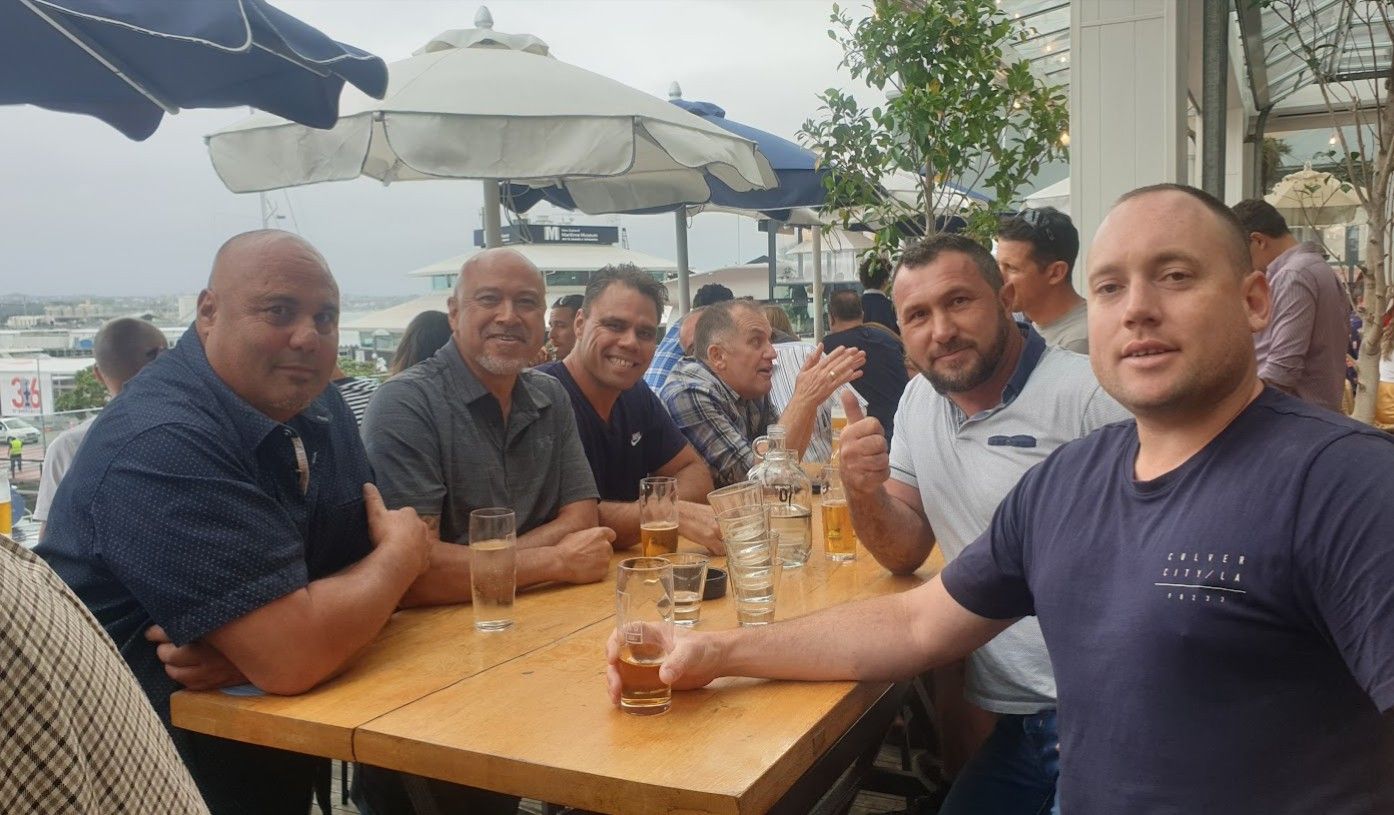 Group of men sitting at an outdoor restaurant table
