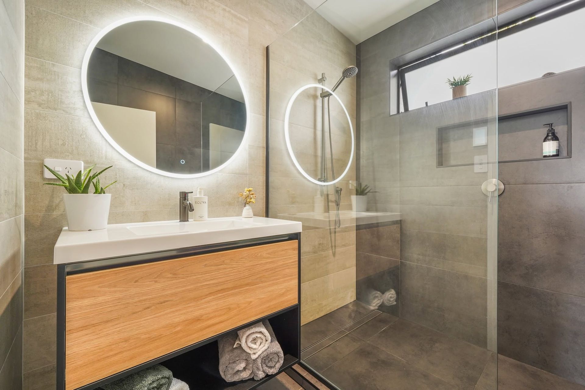 Beautiful bathroom with round backlit mirror
