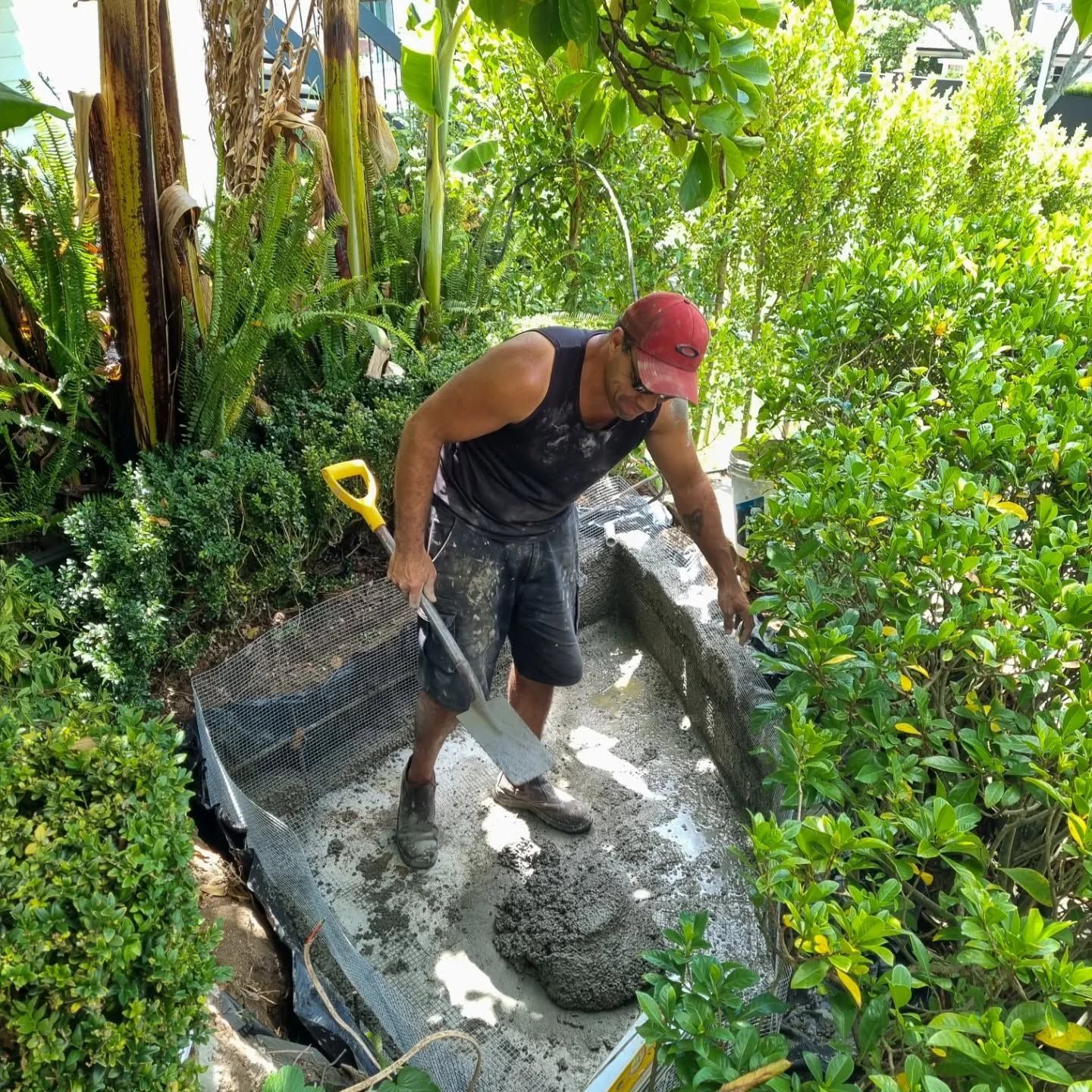 Man digging and working on water fountain
