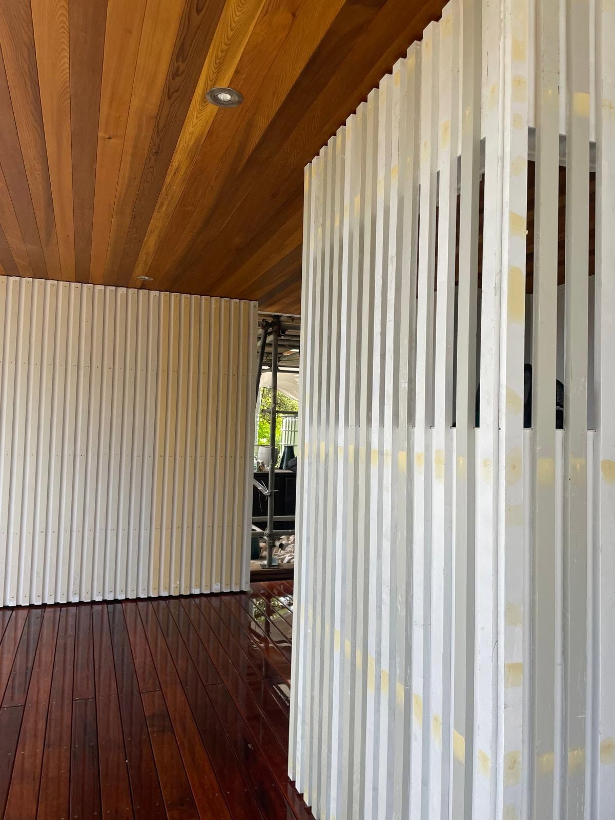 Close-up of wood-paneled ceiling detail with recessed lighting