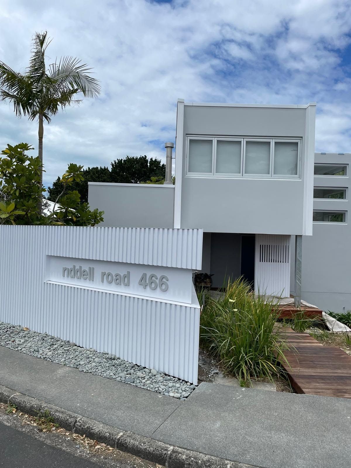 Palm tree beside a white modern building