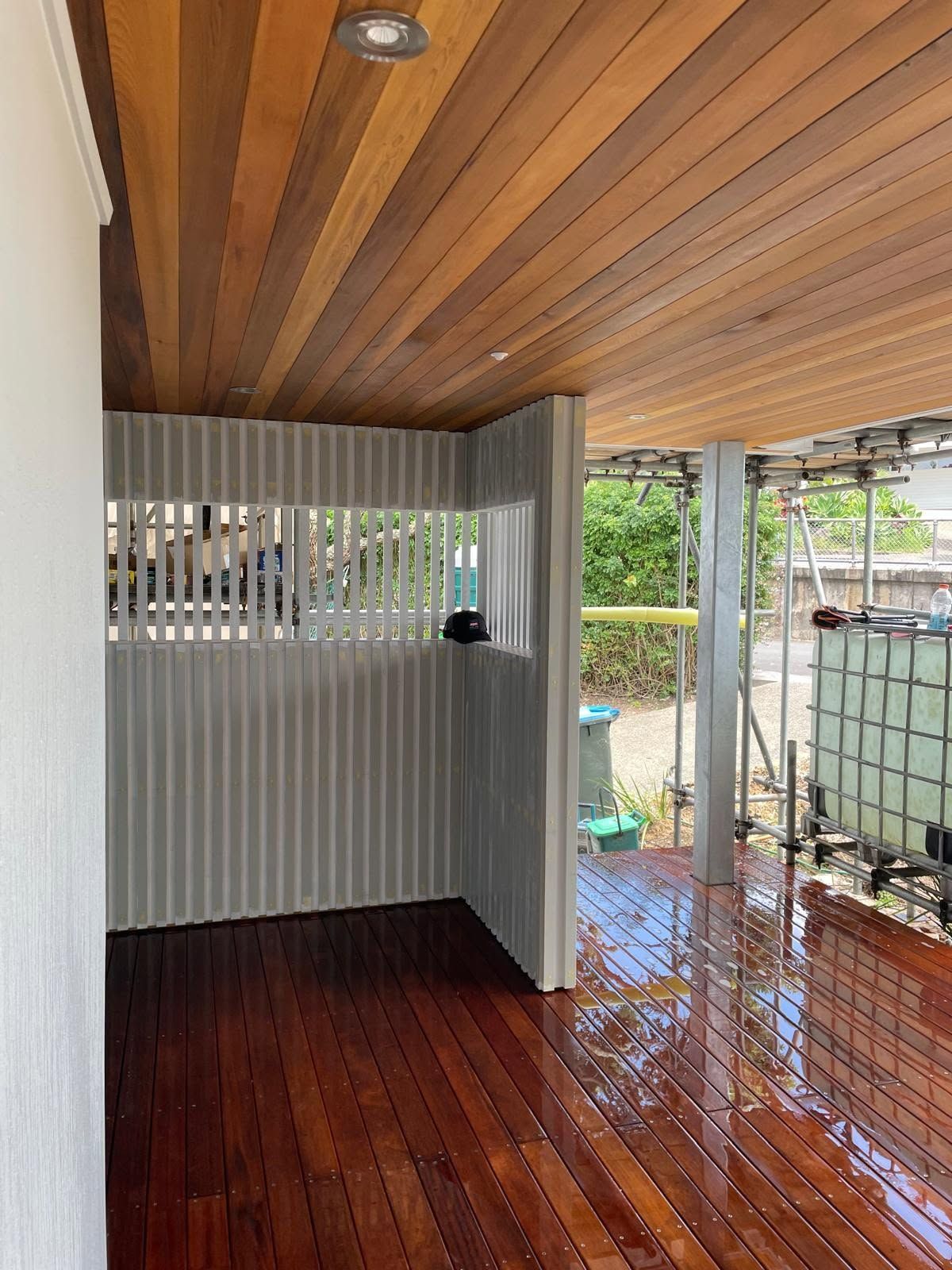 Angled wood-paneled ceiling with slatted screen