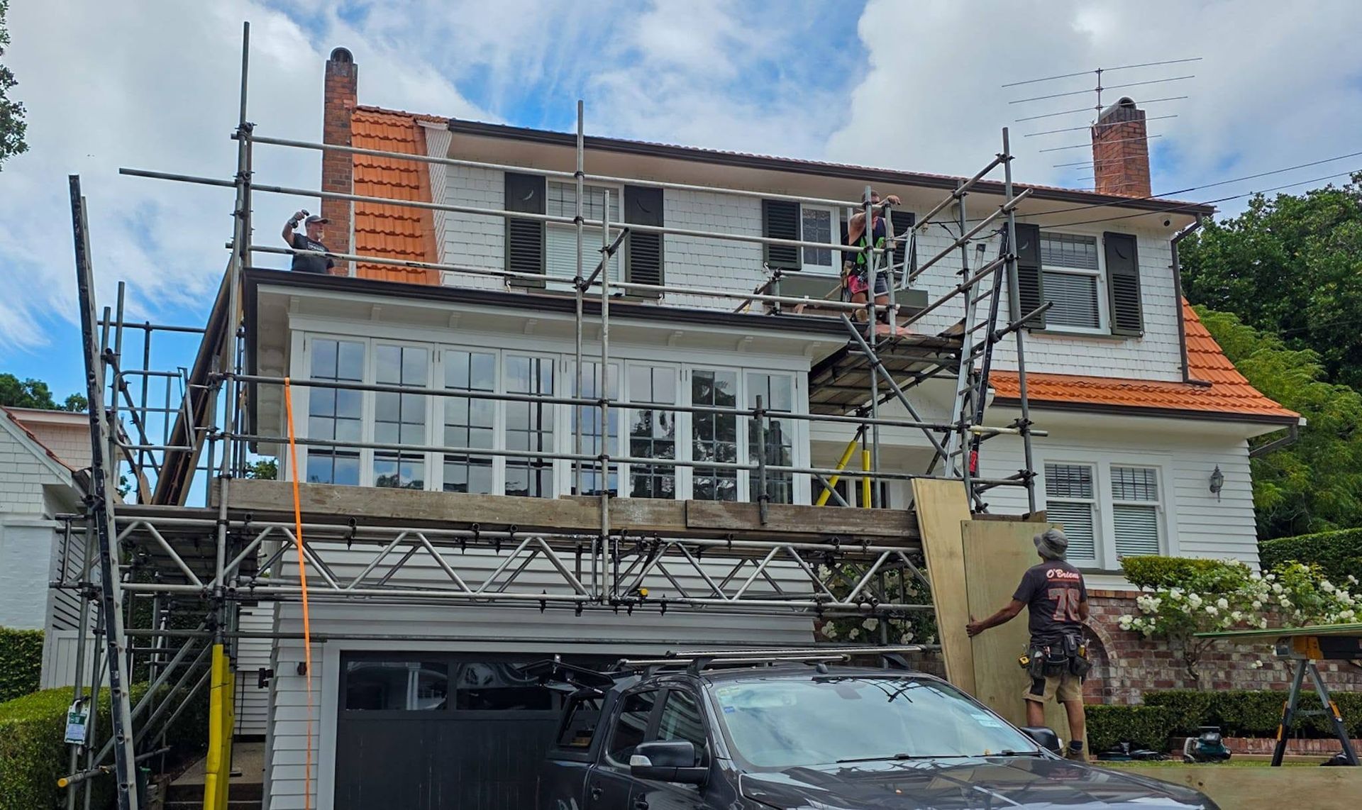 Brick house exterior with scaffolding during renovation