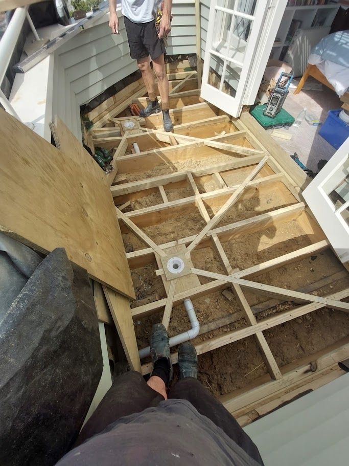 Man standing on a wooden deck under construction