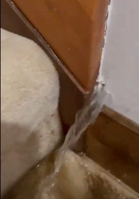 water pouring through the wall