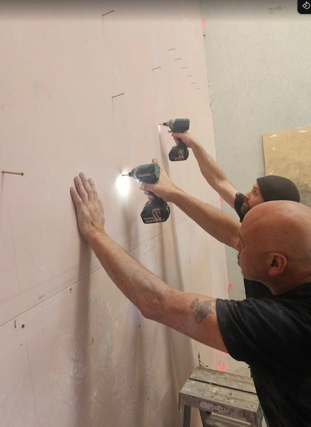 Plasterboard being screwed